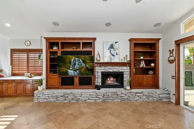 a spacious bathroom with a granite countertop double vanity sink large mirror bathtub and next to a window