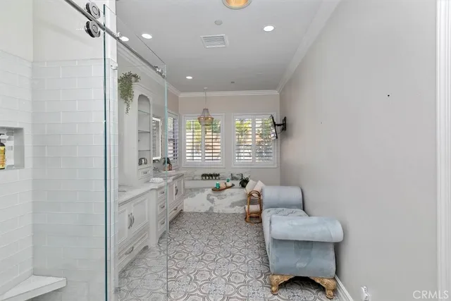 a view of a hallway with dining area and chandelier
