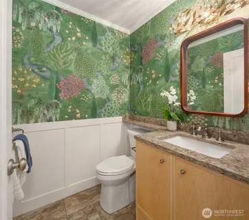 a bathroom with a granite countertop sink a toilet and mirror