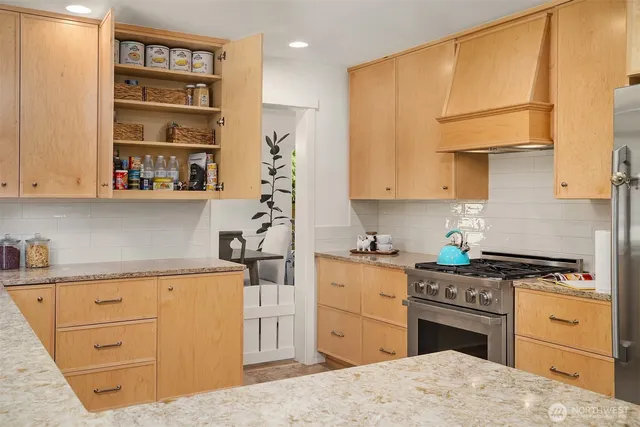 a kitchen with a stove a sink and a refrigerator