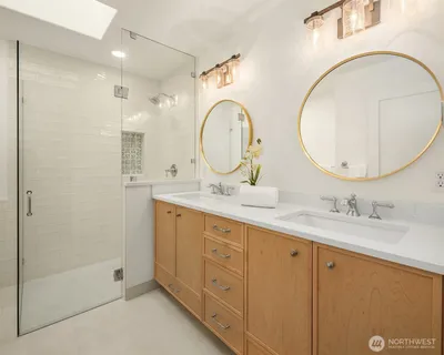 a bathroom with a double vanity sink and a mirror