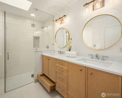 a bathroom with a double vanity sink and a mirror