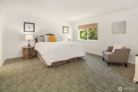 a spacious bedroom with a bed and window