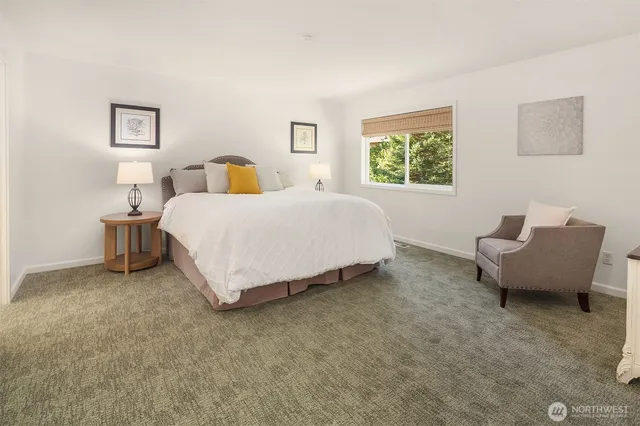 a spacious bedroom with a bed and window