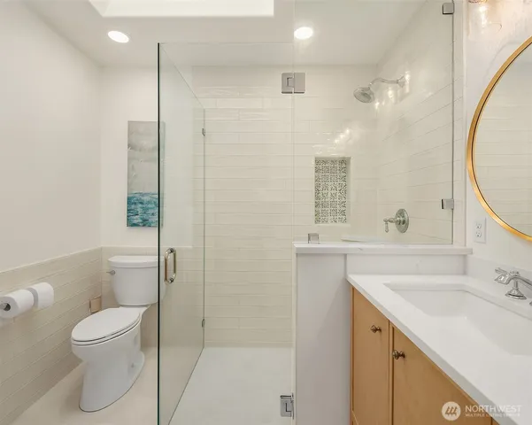 a bathroom with a sink a toilet and shower