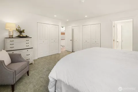 a spacious bedroom with a bed and a couch