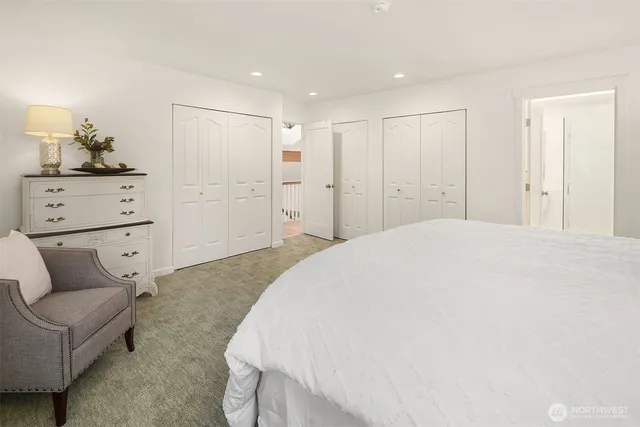 a spacious bedroom with a bed and a couch