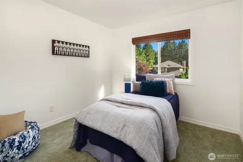 a bed sitting in a bedroom next to a window