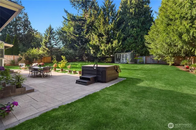 a view of a backyard with sitting area