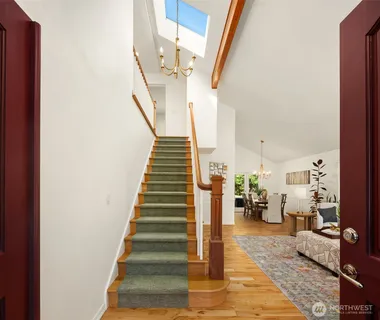 a view of entryway and hall with wooden floor