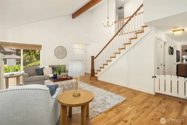 a living room with furniture and a chandelier