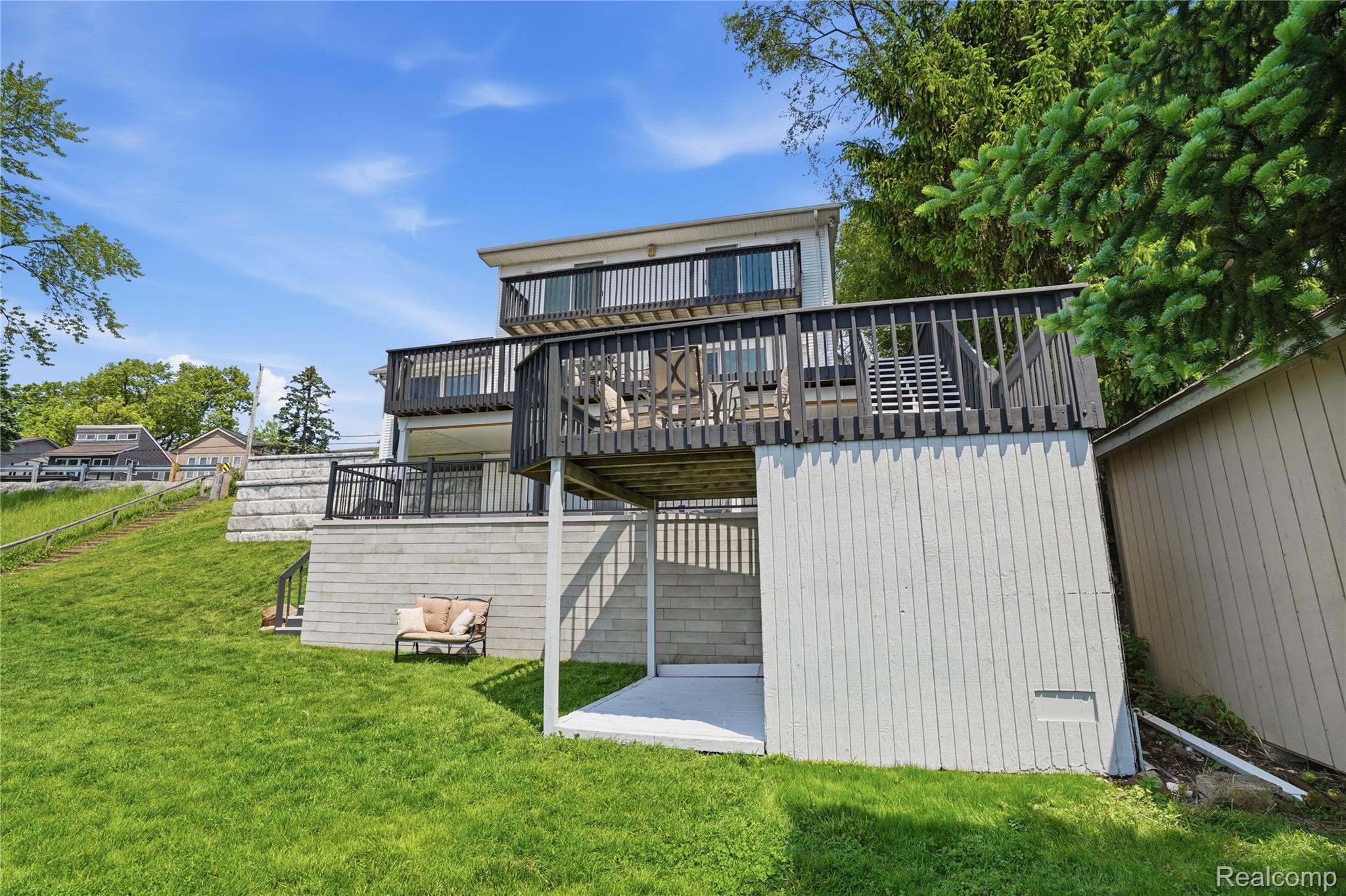 7217 Andersonville Road Clarkston, MI 48346 - Photo 48 of 65 Two-story exterior featuring a lower-level patio and two elevated decks with dark railings