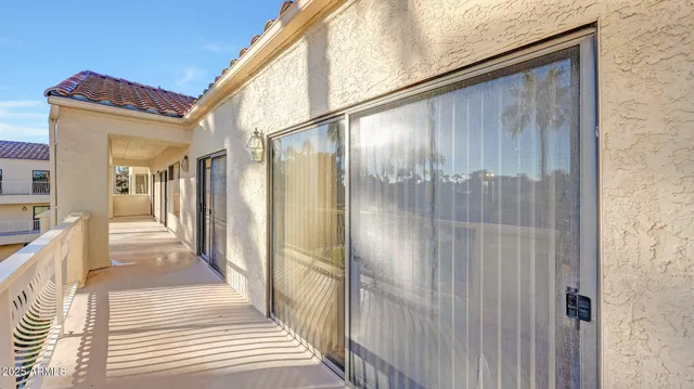 a balcony view with a glass door
