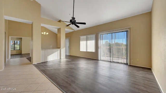 a view of a livingroom with wooden floor and a ceiling fan