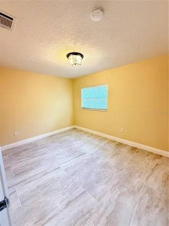 an empty room with a empty space and a window