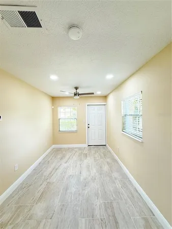 an empty room with windows and closet