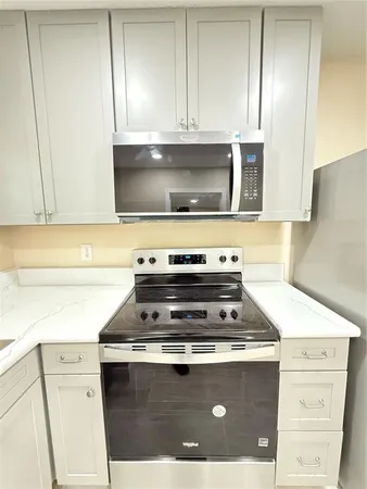 a stove top oven sitting inside of a kitchen