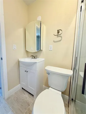a white toilet sitting next to a bathroom sink