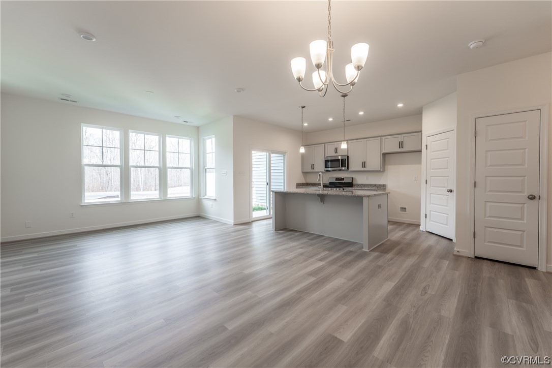 18609 Palisades Ridge Moseley, VA 23120 - Photo 12 of 50 a view of a kitchen with a dishwasher a kitchen island hardwood floor and a window
