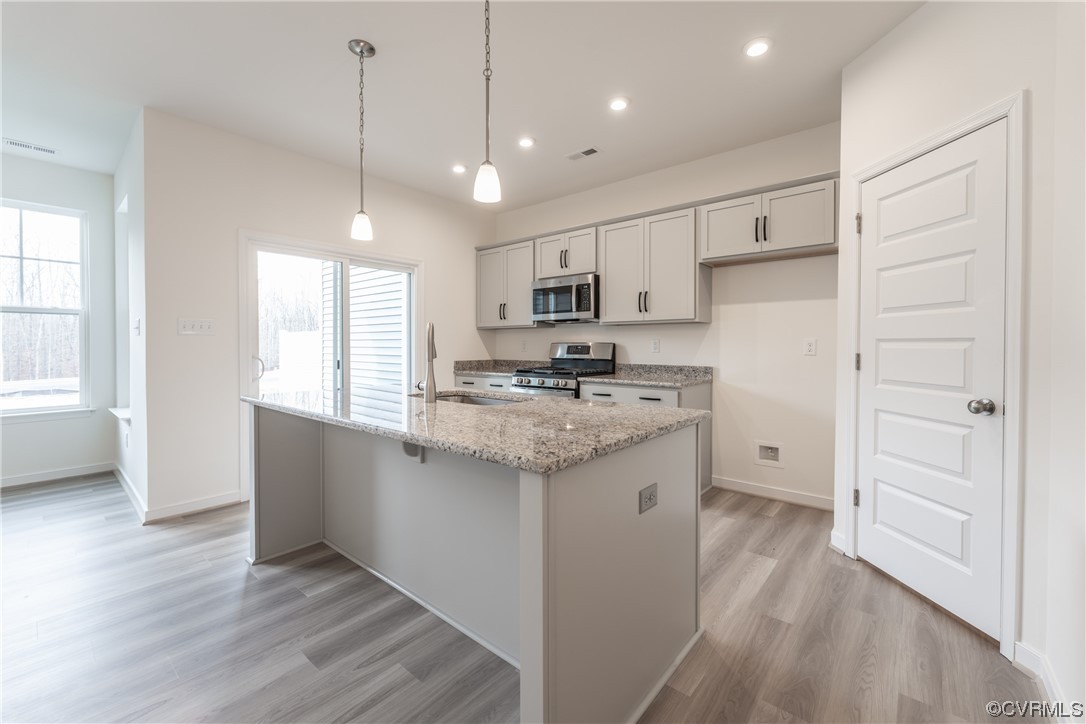 18609 Palisades Ridge Moseley, VA 23120 - Photo 5 of 50 a kitchen with granite countertop a sink cabinets and wooden floor