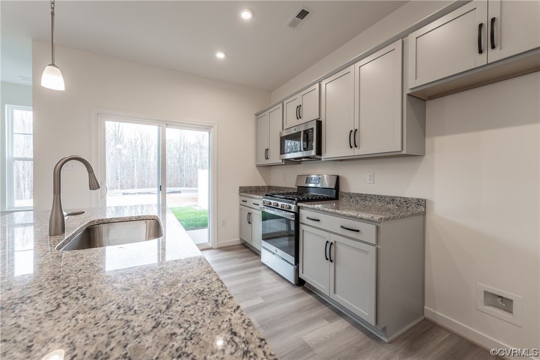 18609 Palisades Ridge Moseley, VA 23120 - Photo 7 of 50 a kitchen with stainless steel appliances granite countertop a sink and a stove top oven
