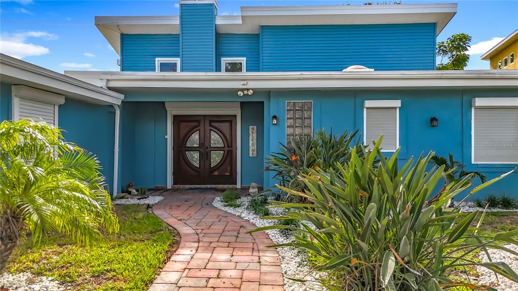 14186 West Parsley Drive Madeira Beach, FL 33708 - Photo 1 of 57 a view of a house with potted plants