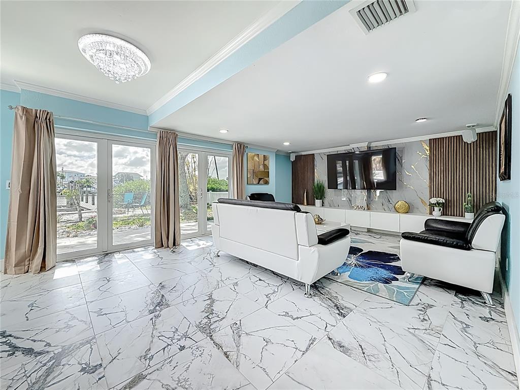 14186 West Parsley Drive Madeira Beach, FL 33708 - Photo 15 of 57 a living room with furniture and a large window