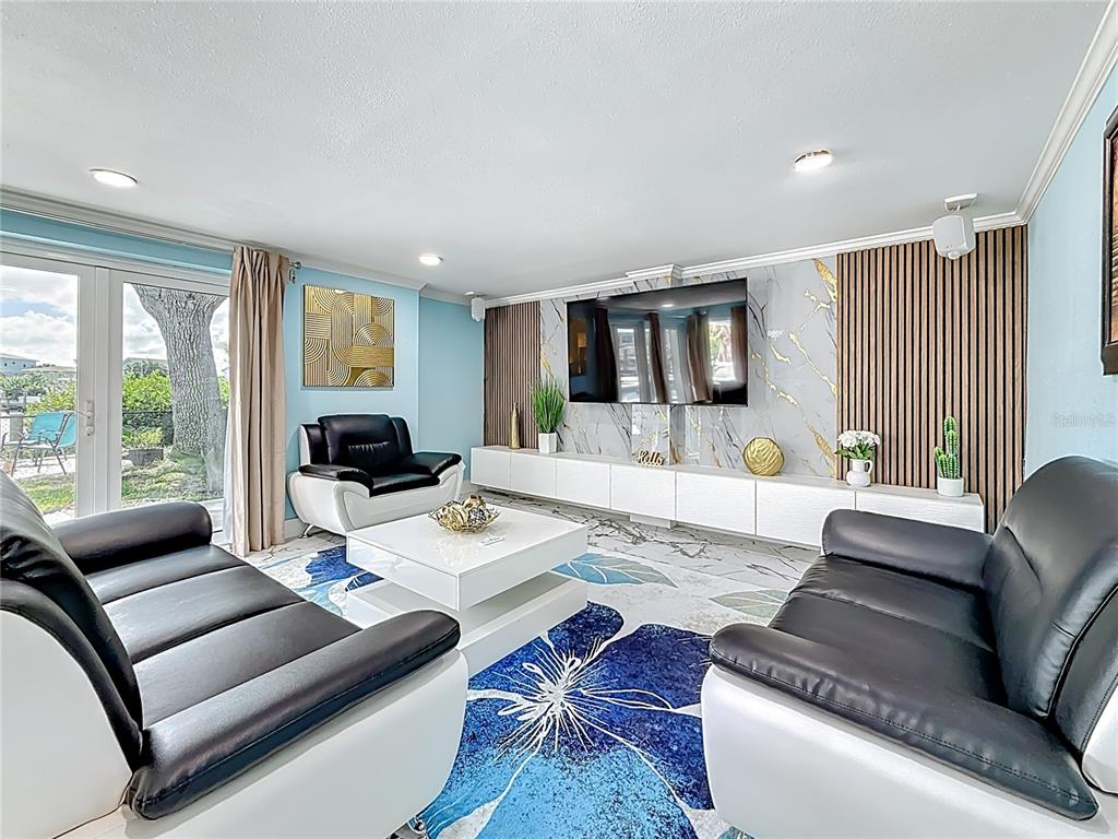 14186 West Parsley Drive Madeira Beach, FL 33708 - Photo 17 of 57 a living room with furniture and a large window