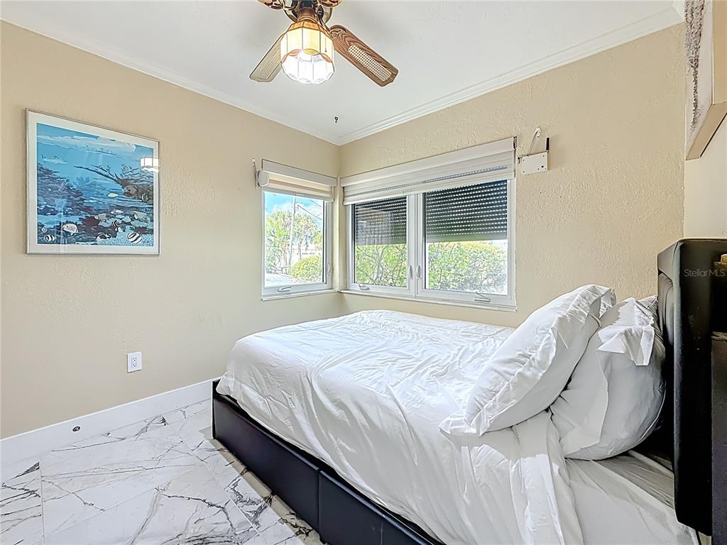 14186 West Parsley Drive Madeira Beach, FL 33708 - Photo 21 of 57 a bedroom with a bed and a window