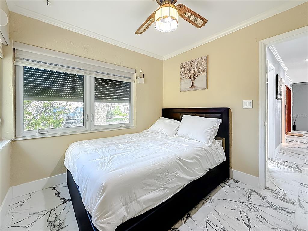 14186 West Parsley Drive Madeira Beach, FL 33708 - Photo 22 of 57 a bedroom with a large bed and a window