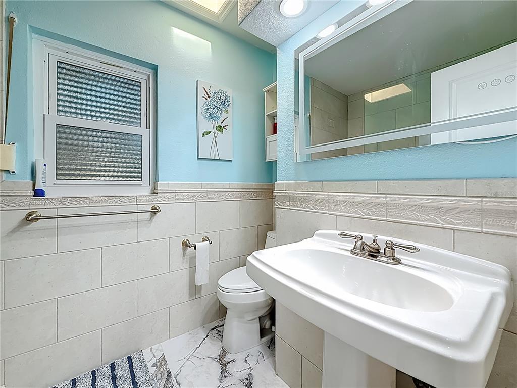 14186 West Parsley Drive Madeira Beach, FL 33708 - Photo 23 of 57 a bathroom with a sink and a toilet