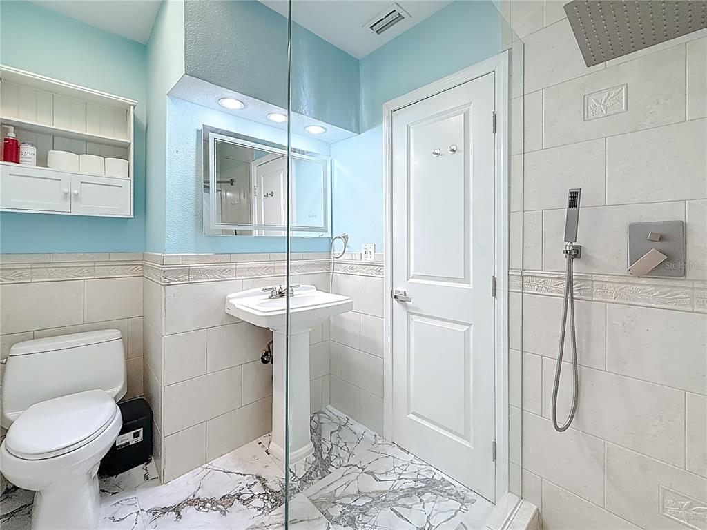 14186 West Parsley Drive Madeira Beach, FL 33708 - Photo 25 of 57 a bathroom with a sink toilet and shower
