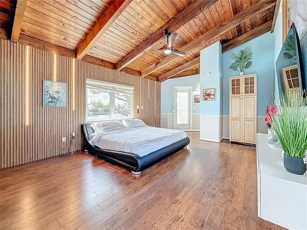 a view of a house with wooden deck and furniture