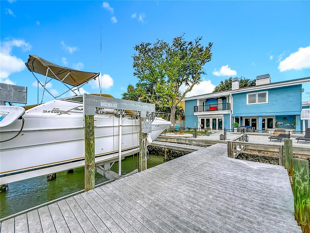 14186 West Parsley Drive Madeira Beach, FL 33708 - Photo 48 of 57 a view of a house with wooden deck and furniture