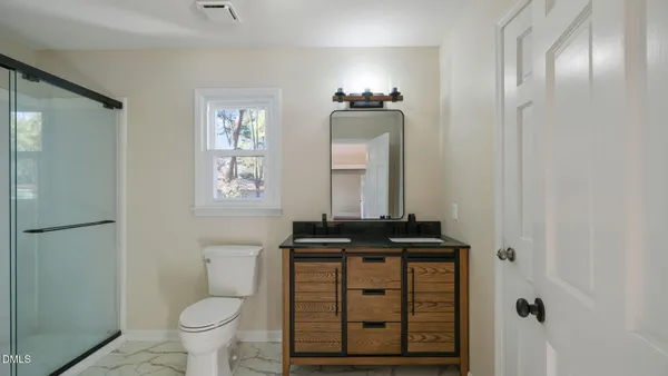 an empty room with wooden floor and ceiling fan
