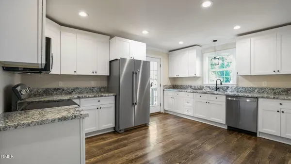 a kitchen with granite countertop a sink and cabinets