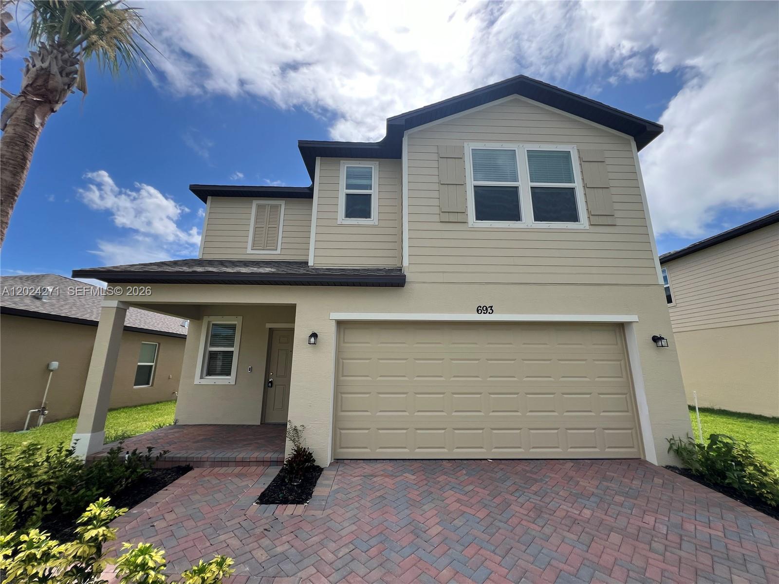 693 Carlyle Way Fort Pierce, FL 34947 - Photo 1 of 19 a front view of a house with a yard