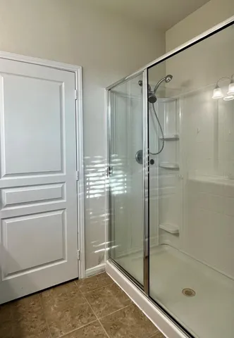 a bathroom with a glass shower door