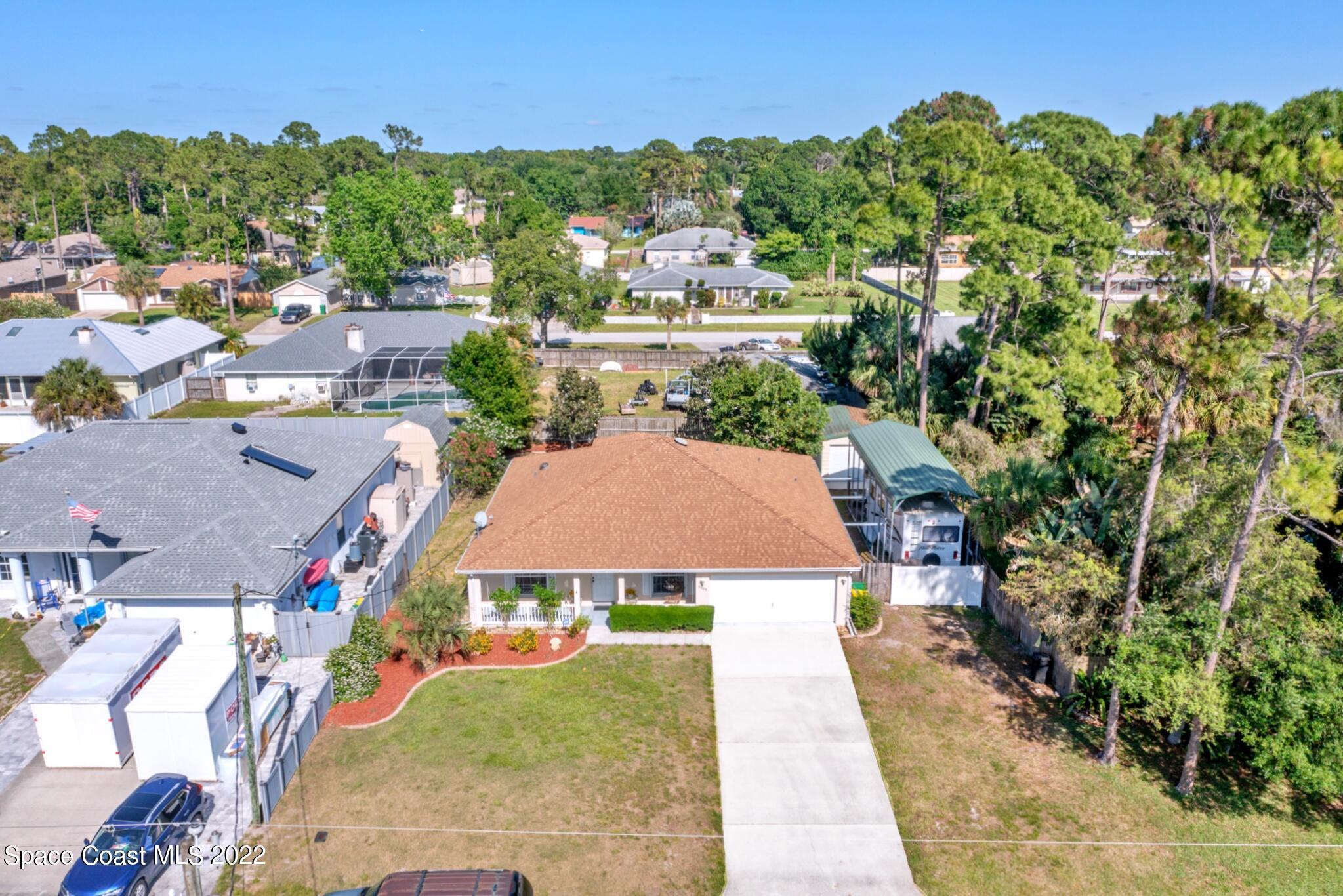 5449 Flint Road Cocoa, FL 32927 - Photo 1 of 36 an aerial view of a house with yard swimming pool and outdoor seating