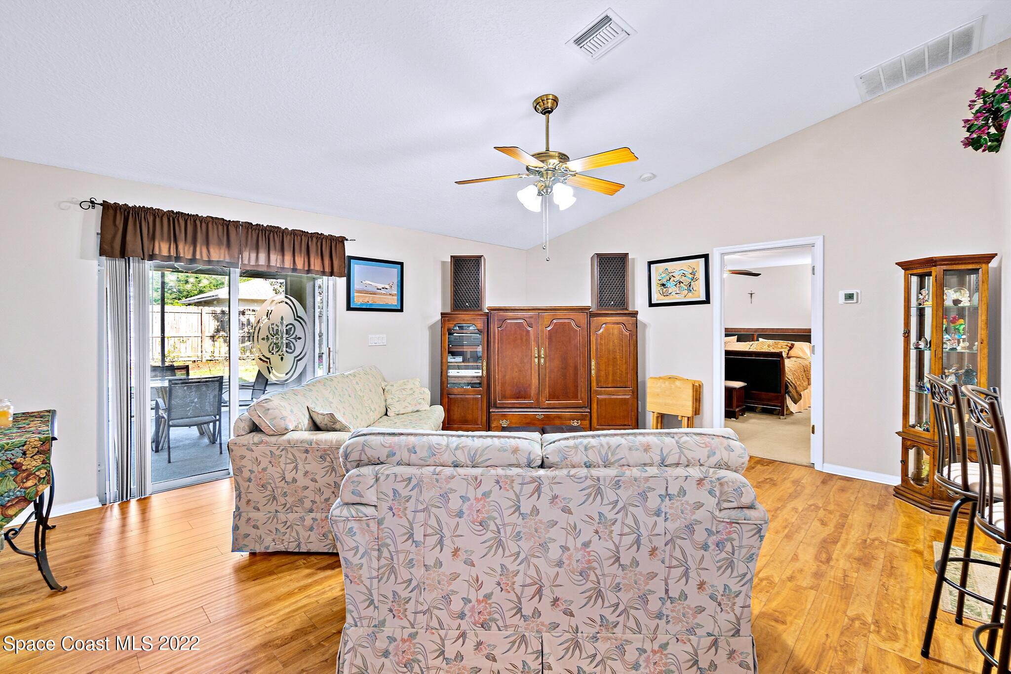 5449 Flint Road Cocoa, FL 32927 - Photo 12 of 36 a living room with furniture a fireplace and a flat screen tv
