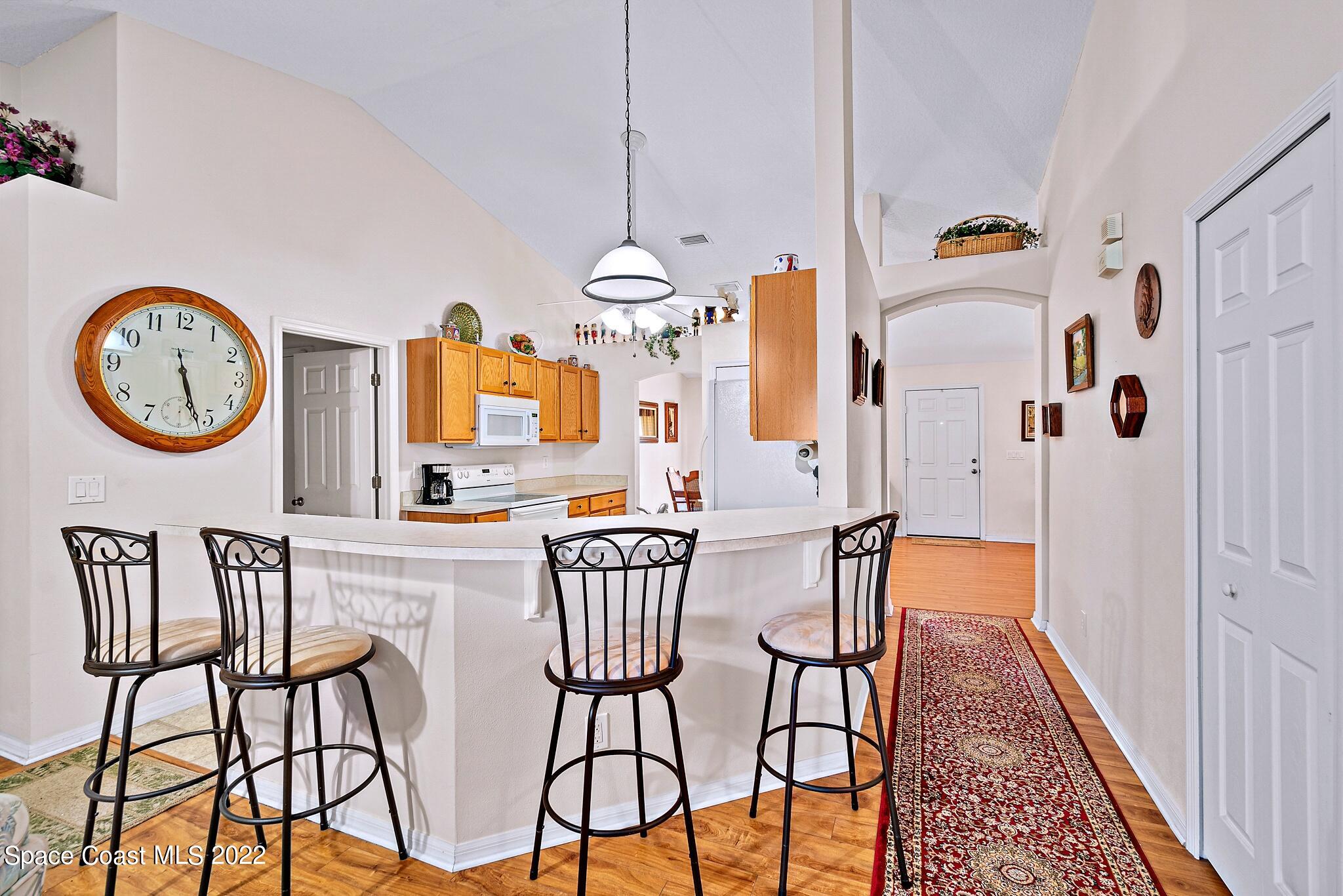 5449 Flint Road Cocoa, FL 32927 - Photo 14 of 36 a view of a dining room with furniture and a chandelier