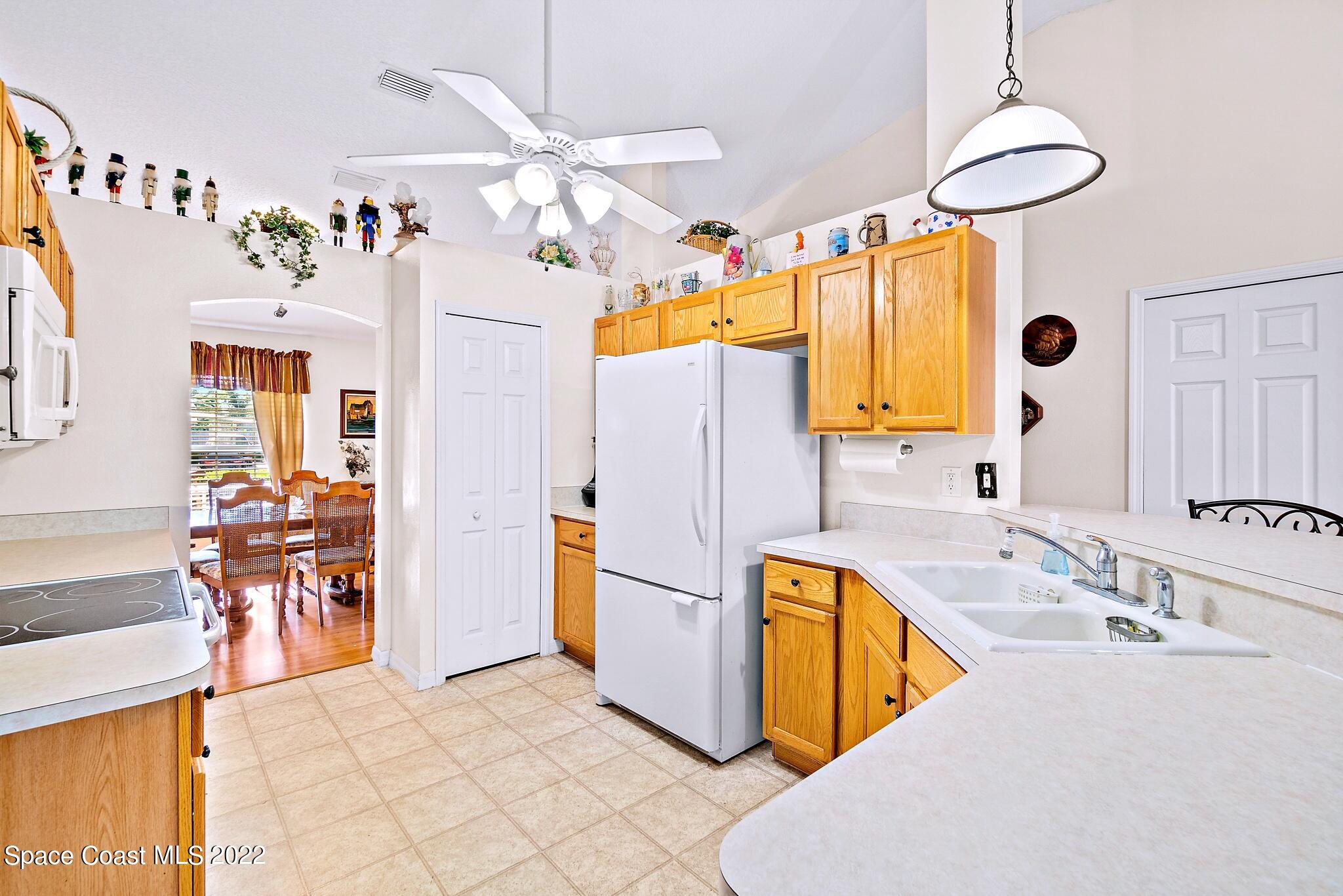 5449 Flint Road Cocoa, FL 32927 - Photo 15 of 36 a kitchen with stainless steel appliances granite countertop a sink a stove and refrigerator