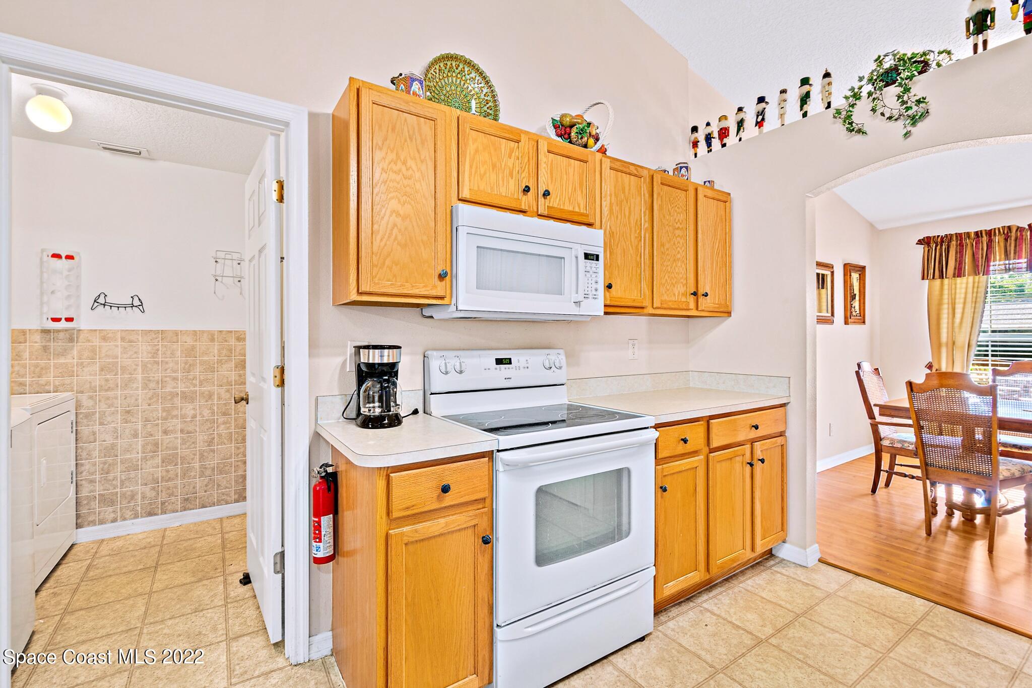 5449 Flint Road Cocoa, FL 32927 - Photo 17 of 36 a kitchen with stainless steel appliances granite countertop a sink and cabinets