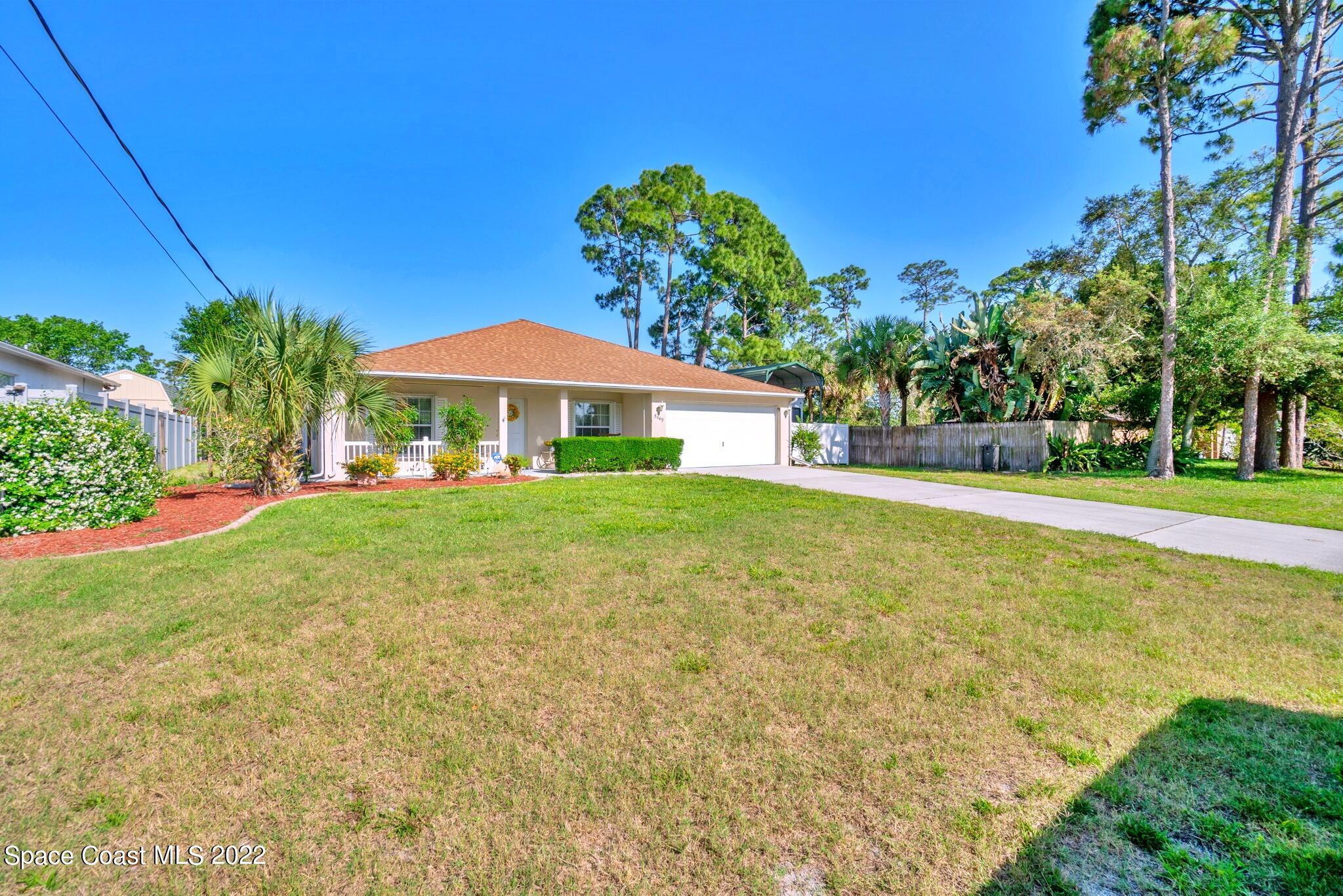 5449 Flint Road Cocoa, FL 32927 - Photo 2 of 36 a front view of a house with garden
