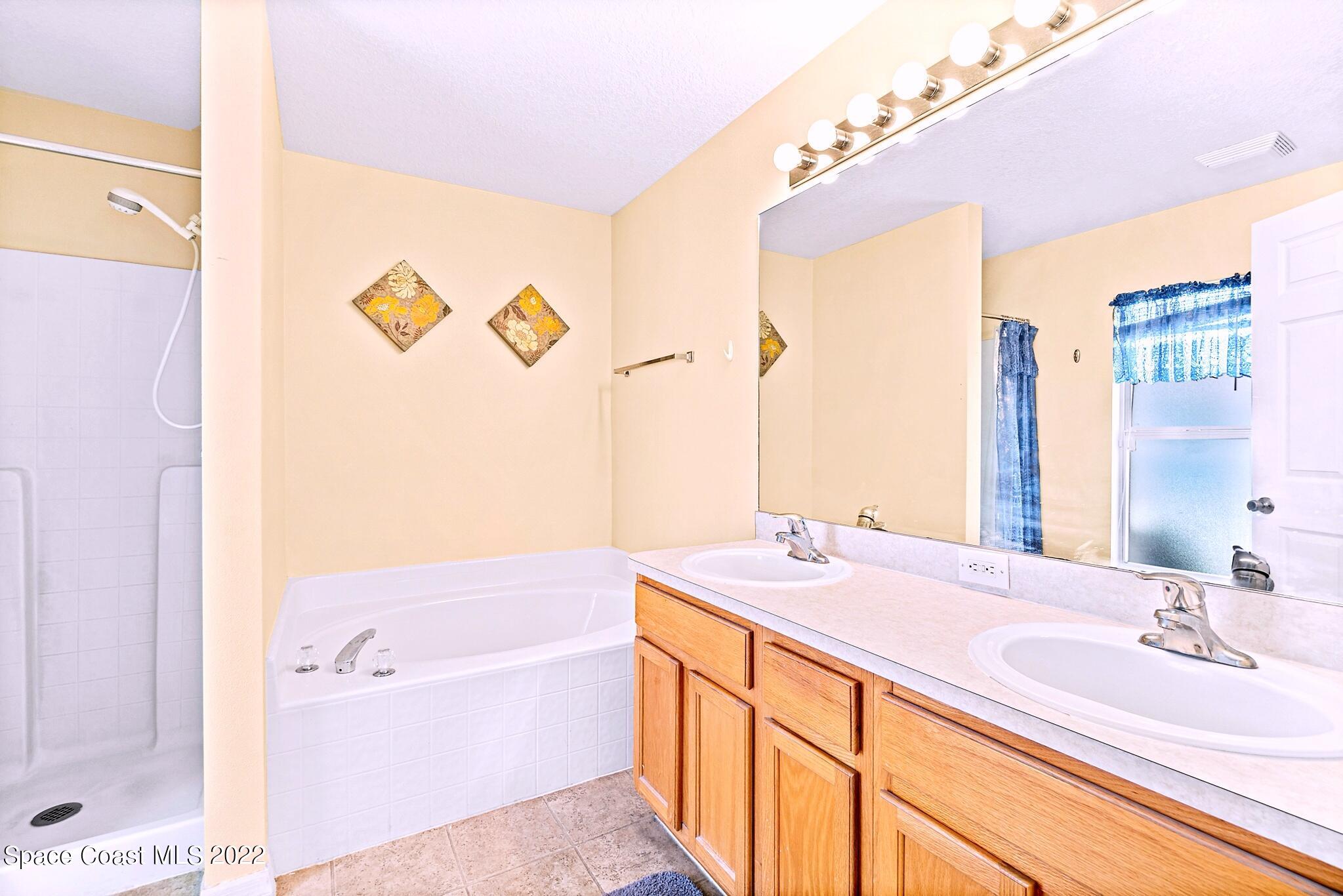 5449 Flint Road Cocoa, FL 32927 - Photo 21 of 36 a bathroom with a granite countertop sink and a mirror