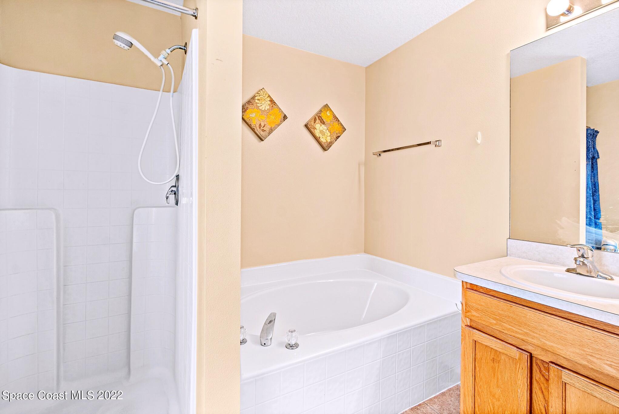5449 Flint Road Cocoa, FL 32927 - Photo 22 of 36 a bathroom with a bathtub and a sink
