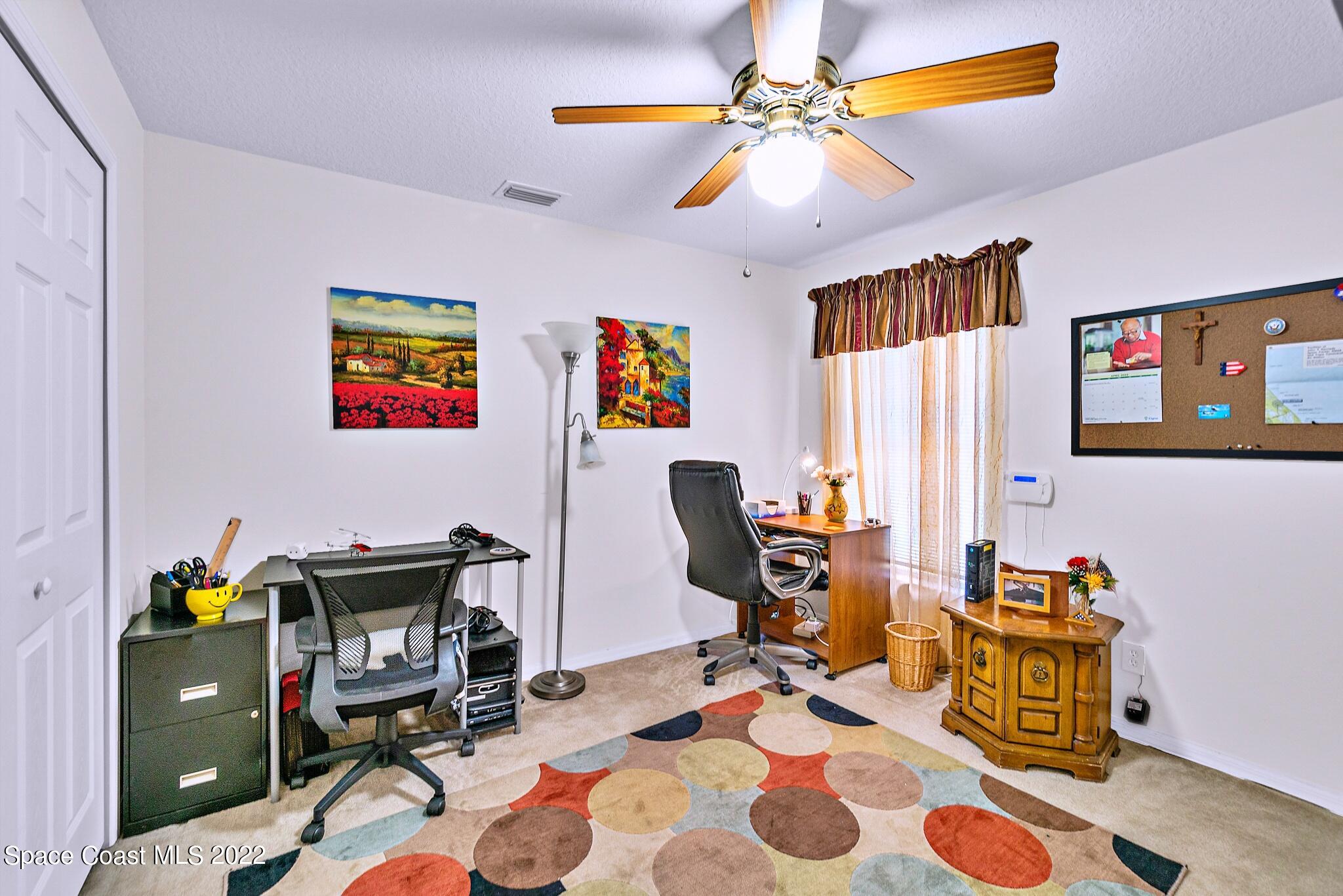 5449 Flint Road Cocoa, FL 32927 - Photo 24 of 36 a view of a workspace with furniture and a window