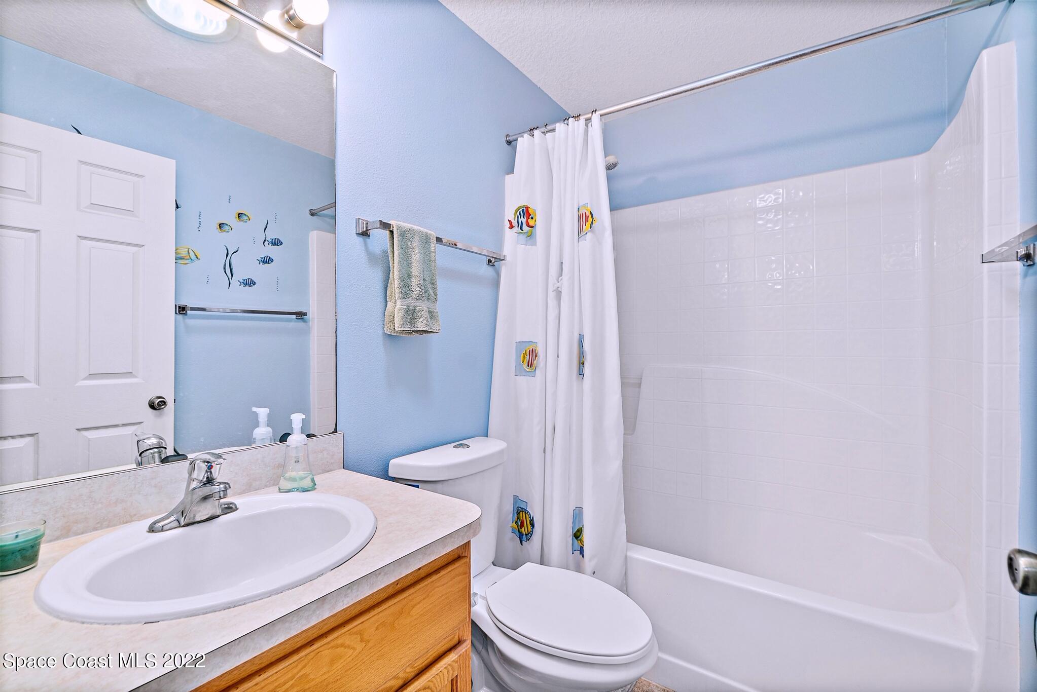 5449 Flint Road Cocoa, FL 32927 - Photo 25 of 36 a bathroom with a sink toilet and shower