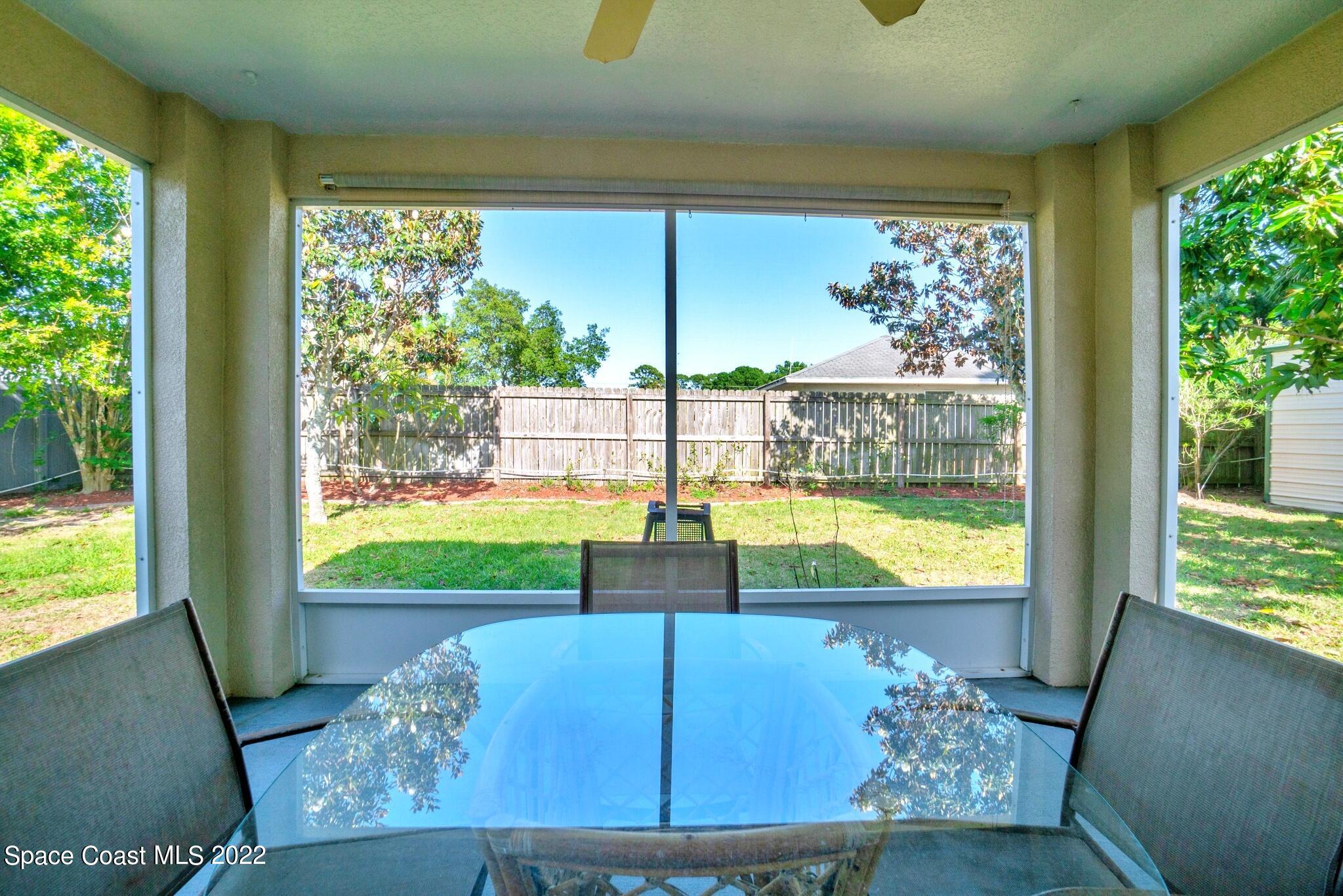 5449 Flint Road Cocoa, FL 32927 - Photo 28 of 36 a view of a living room and floor to ceiling window