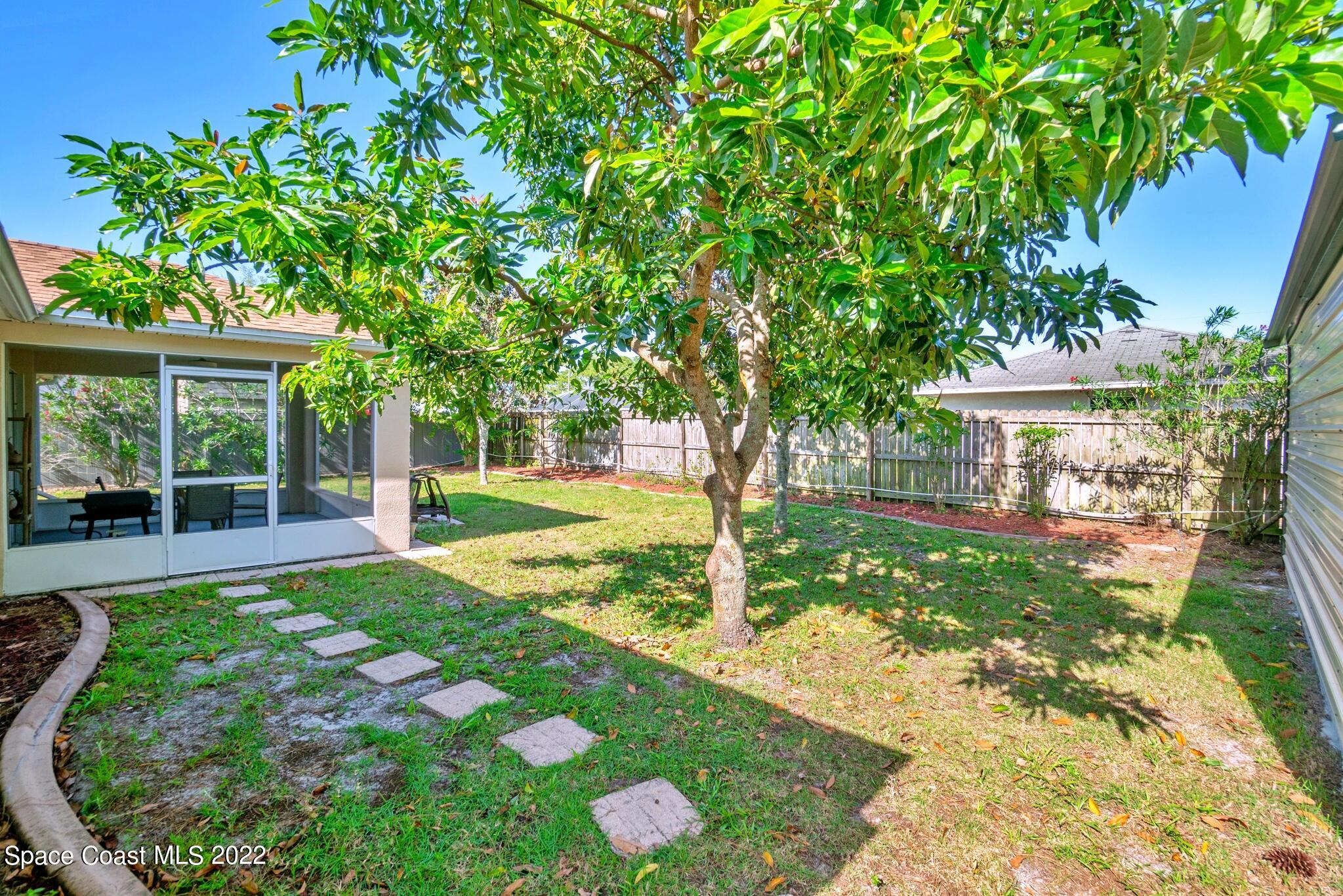 5449 Flint Road Cocoa, FL 32927 - Photo 32 of 36 a view of a house with a yard and tree s